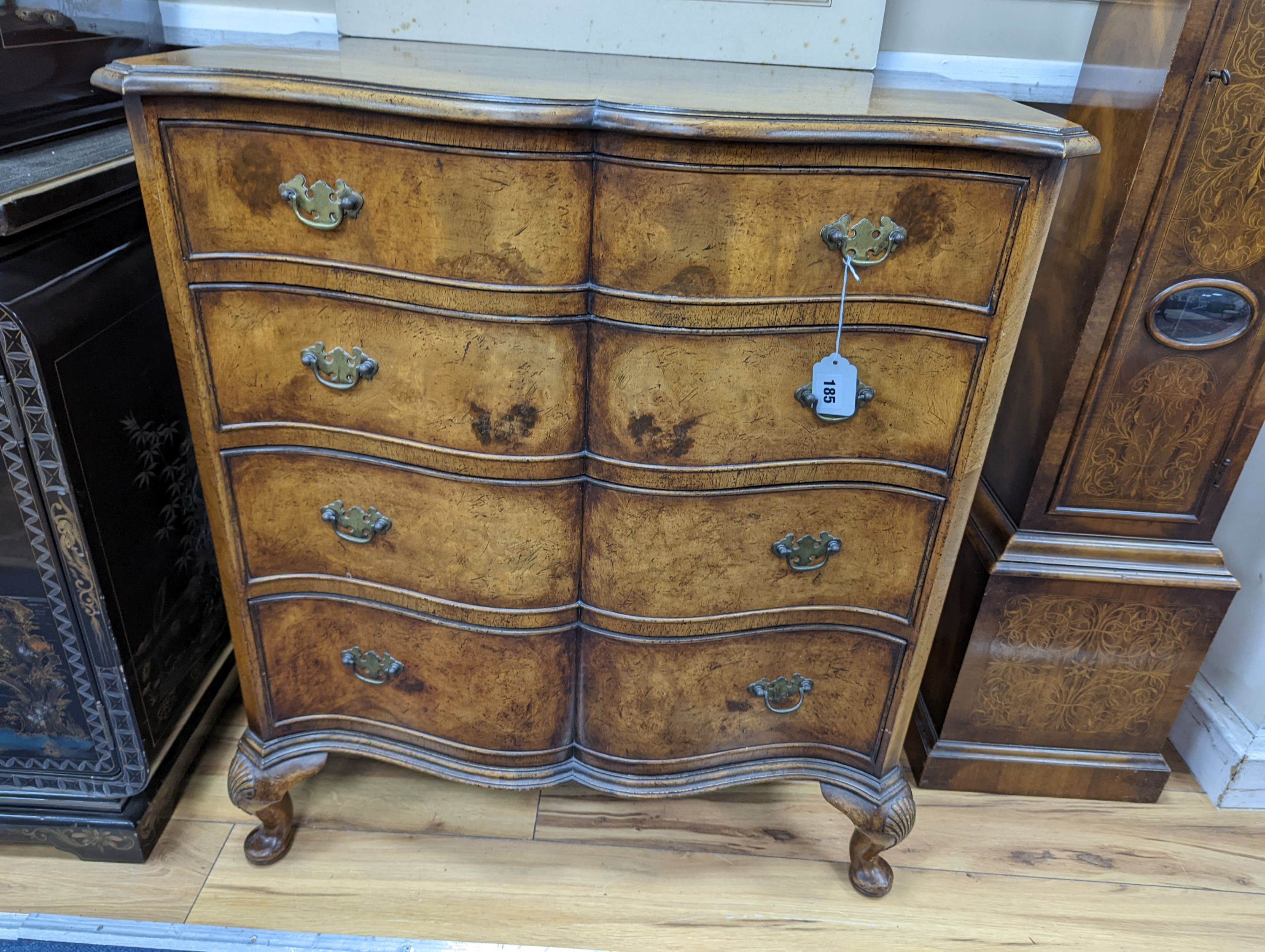 A 1920's Queen Anne revival banded walnut shaped front chest, width 76cm, depth 46cm, height 85cm